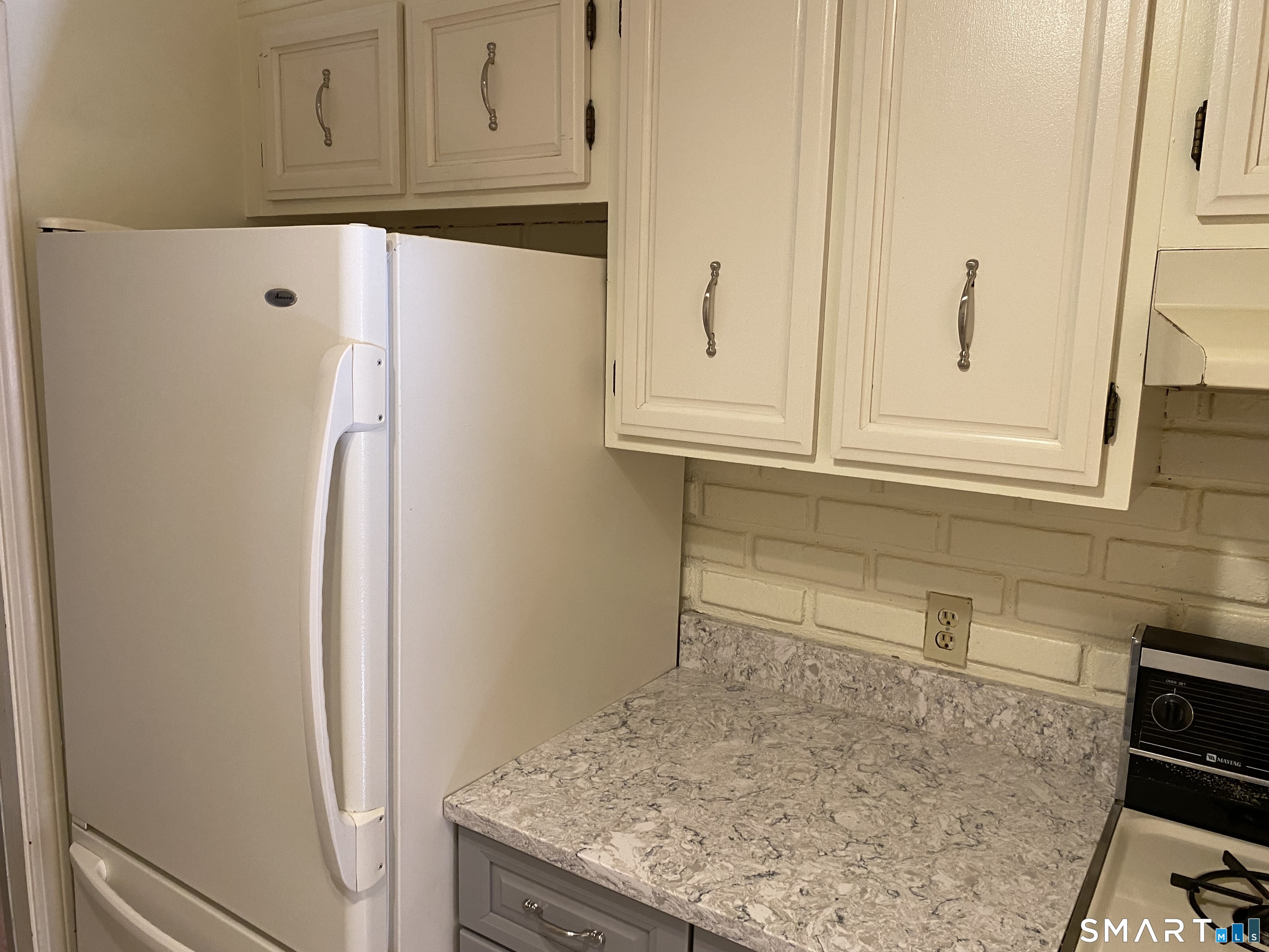 57 Carriage Path South Milford, CT 06460 - Photo 9 of 11 a kitchen with granite countertop cabinets and refrigerator