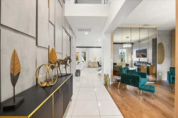 a kitchen with stainless steel appliances kitchen island granite countertop a refrigerator oven a sink a stove and white cabinets