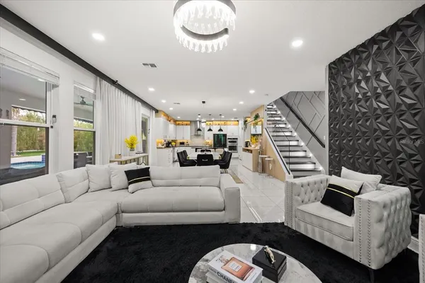 a kitchen with stainless steel appliances granite countertop a sink and a refrigerator