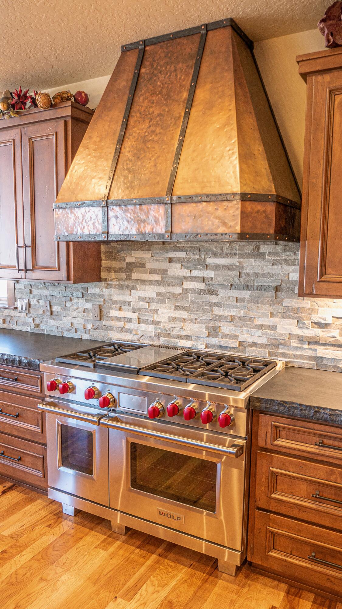 56988 Dancing Rock Loop Bend, OR 97707 - Photo 13 of 49 A hammered cooper hood and farm sink are beautiful and nearly art unto themselves.