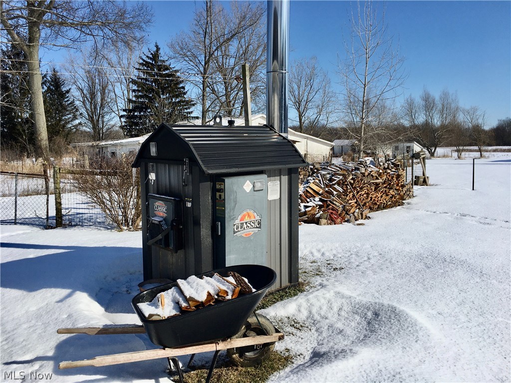 4455 Beat Road Litchfield, OH 44253 - Photo 28 of 35 This outdoor wood furnace makes for a great secondary heat source to the home.