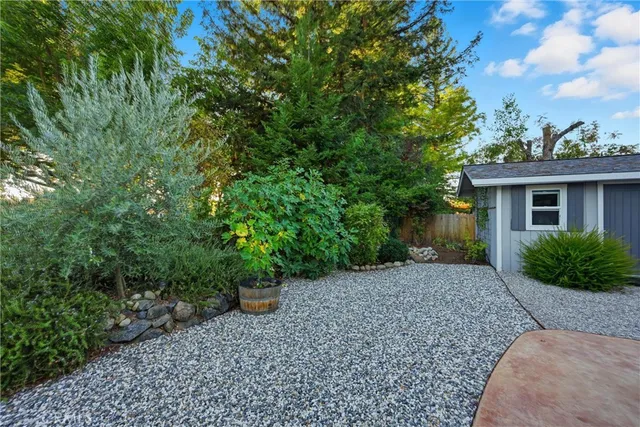 a view of a house with backyard sitting area and garden