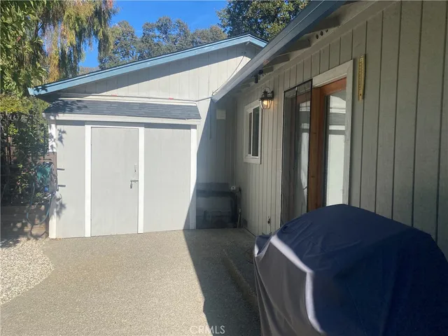a view of a house with backyard and potted plants