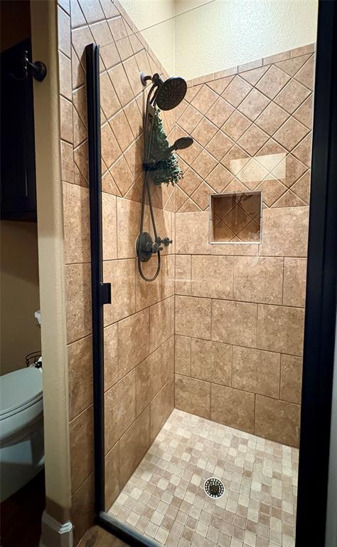104 Adobe Cove Georgetown, TX 78633 - Photo 18 of 40 Step into this shower, complete with rich tile work and a convenient built-in niche.