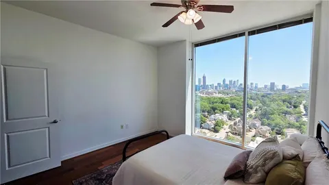 a bedroom with a large bed and a window