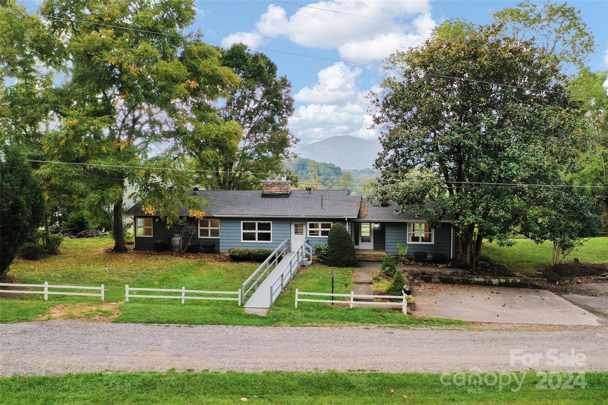 346 Calhoun Road Waynesville, NC 28786 - Photo 3 of 30 a front view of a house with a yard and trees