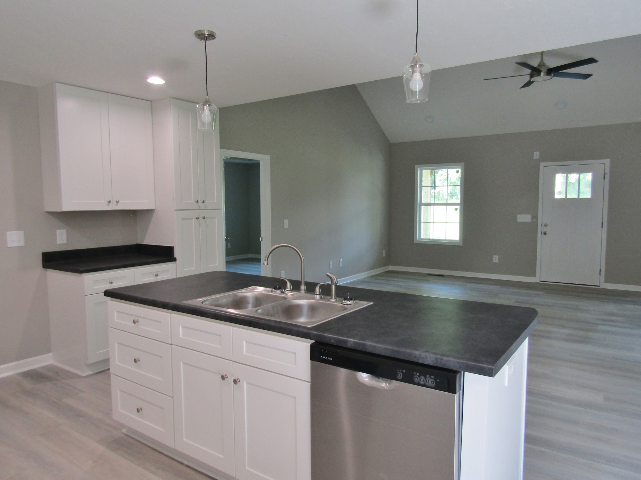 308 Ostella Road Cornersville, TN 37047 - Photo 11 of 19 a kitchen with granite countertop a sink and white cabinets