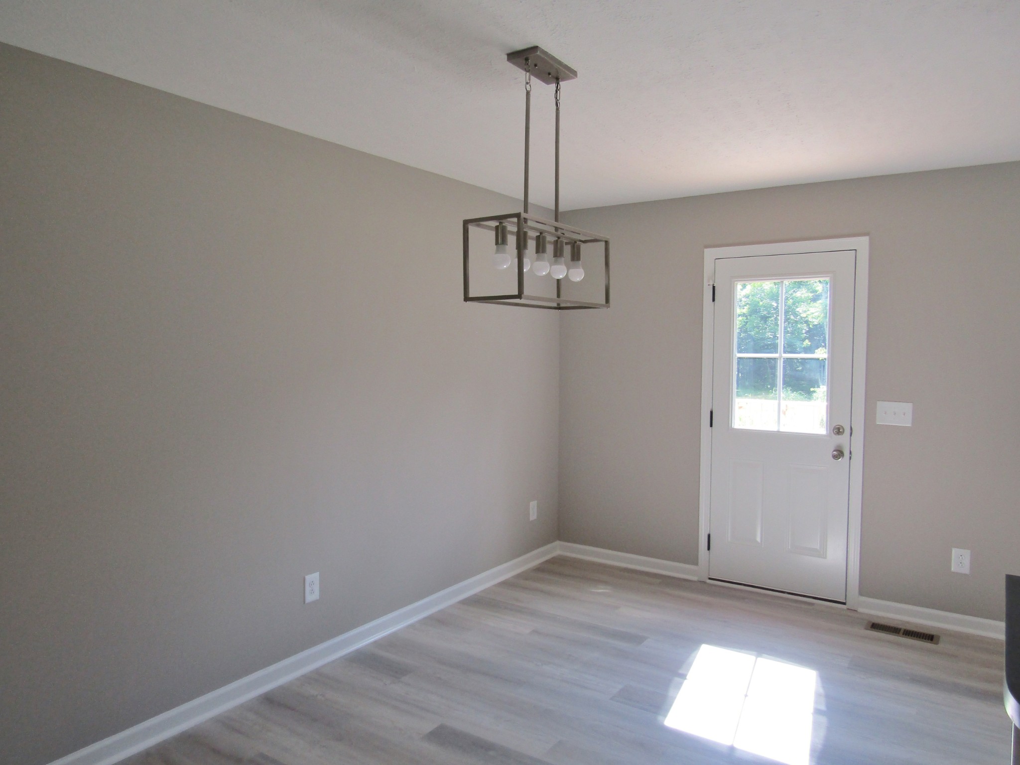 308 Ostella Road Cornersville, TN 37047 - Photo 12 of 19 a view of empty room with wooden floor and window