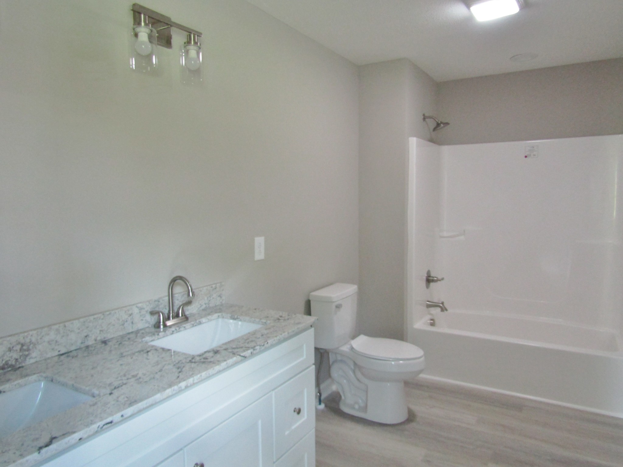 308 Ostella Road Cornersville, TN 37047 - Photo 14 of 19 a bathroom with a granite countertop sink a toilet and shower