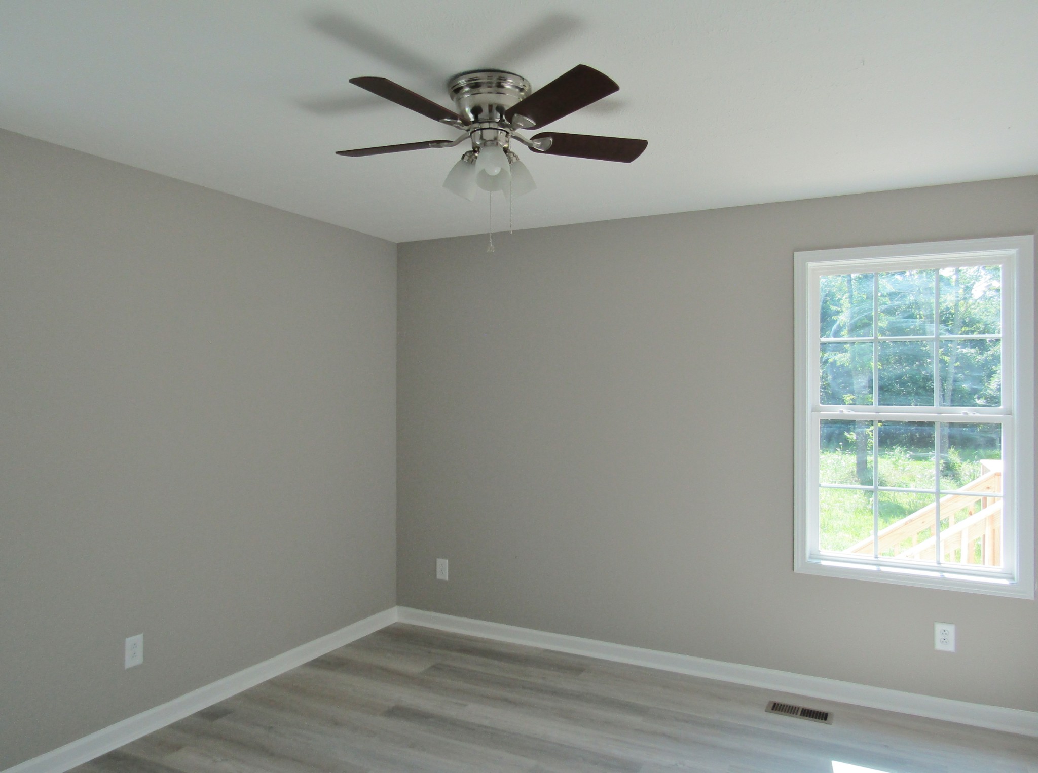 308 Ostella Road Cornersville, TN 37047 - Photo 15 of 19 an empty room with wooden floor and windows