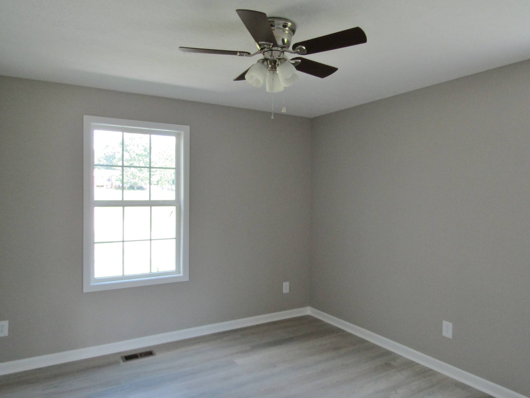 308 Ostella Road Cornersville, TN 37047 - Photo 18 of 19 an empty room with a window and a fan