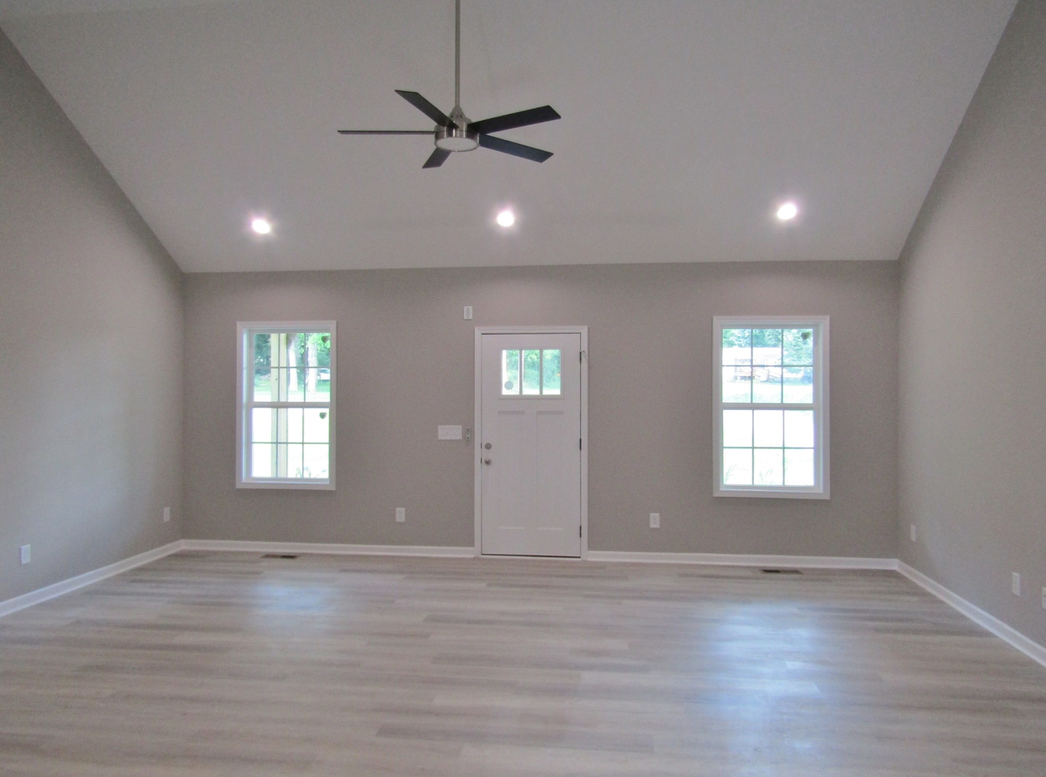 308 Ostella Road Cornersville, TN 37047 - Photo 5 of 19 a view of an empty room with wooden floor and window