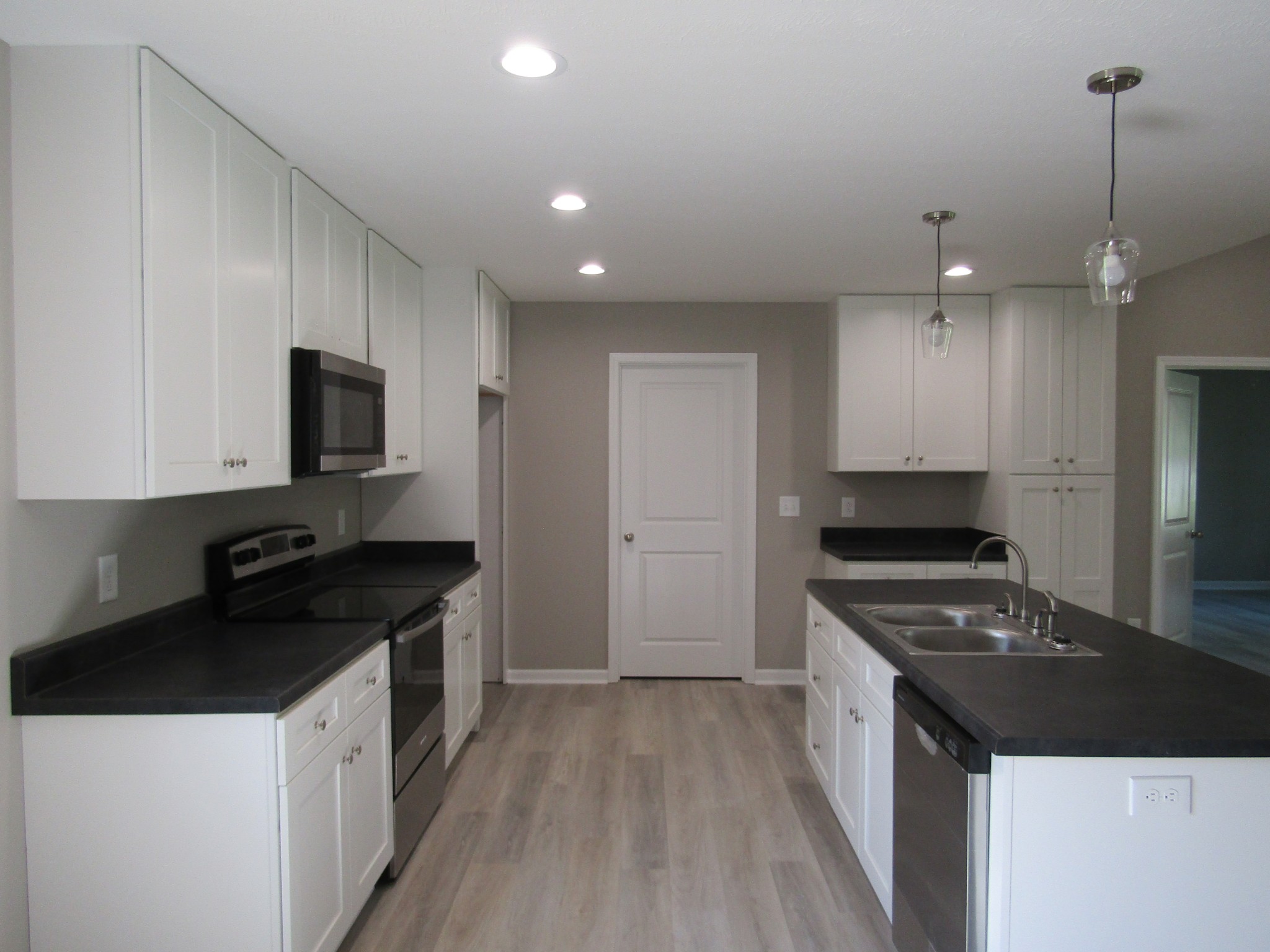 308 Ostella Road Cornersville, TN 37047 - Photo 9 of 19 a kitchen with granite countertop a stove and a sink