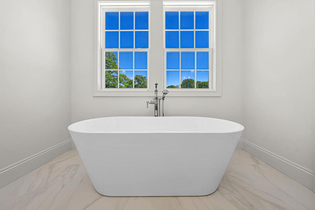 707 Vickery Street Extension Hartwell, GA 30643 - Photo 21 of 50 A freestanding soaking tub provides a serene escape with views of nature through ample windows.