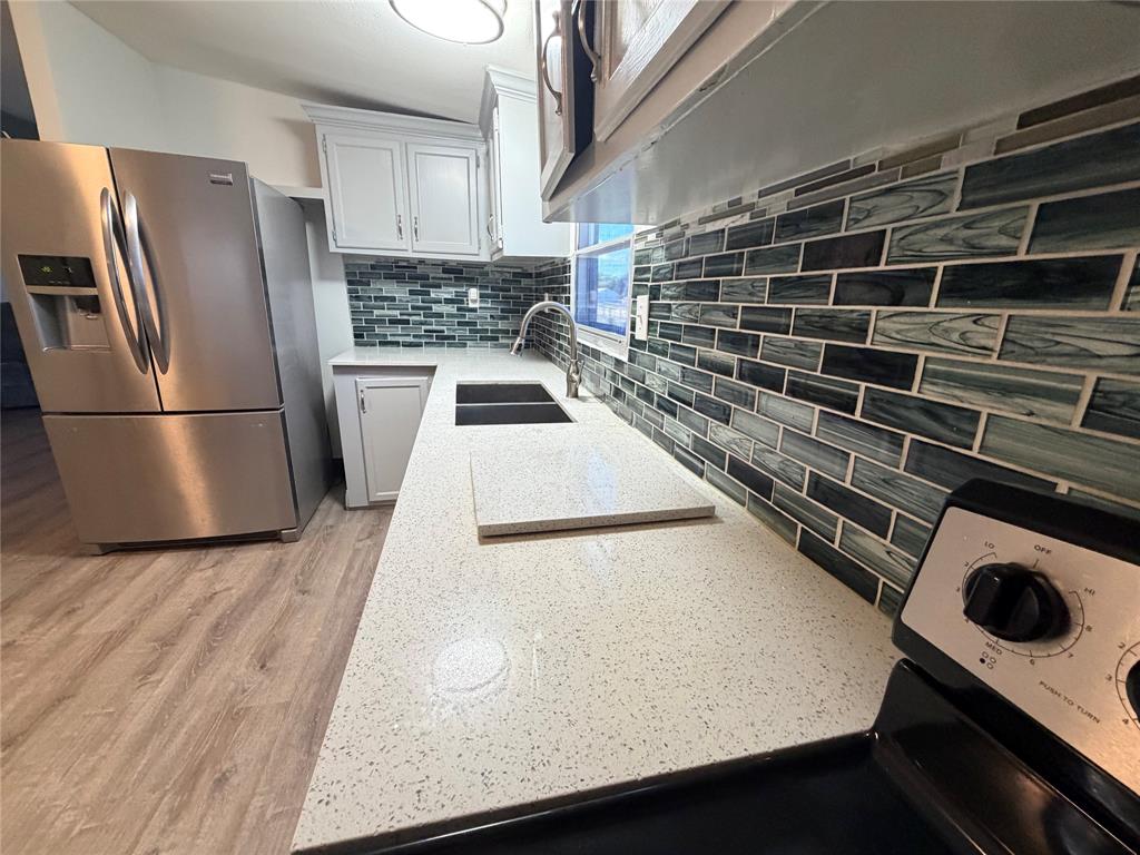 222 Hix Road Cleburne, TX 76031 - Photo 7 of 27 a kitchen with a refrigerator and a stove top oven