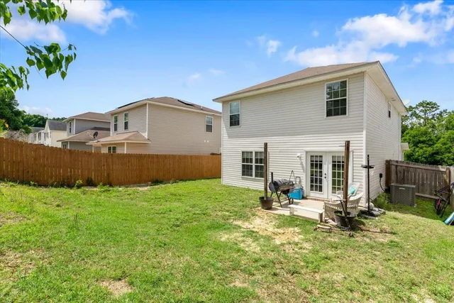 a view of a house with backyard and sitting area