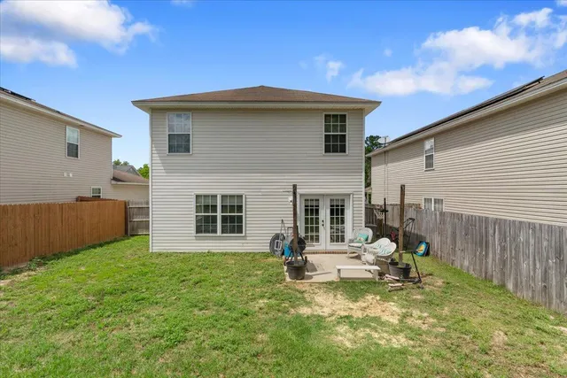 a backyard of a house with table and chairs