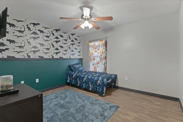 a living room with hard wood flooring and a couch