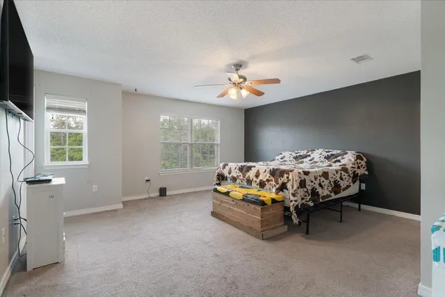 a bed sitting in a bedroom next to a window