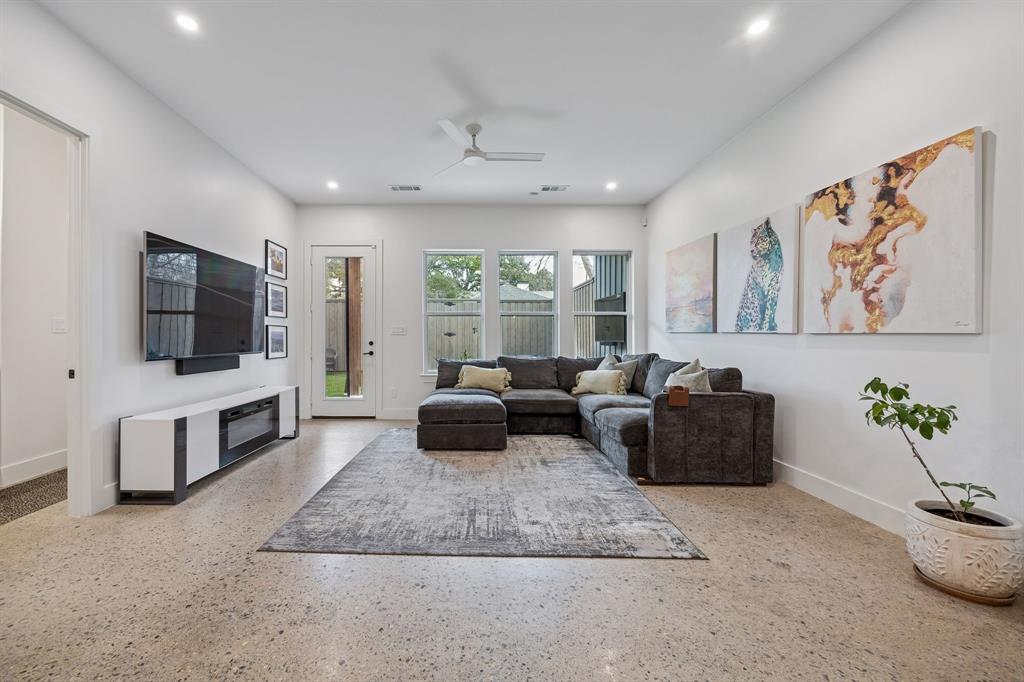 5104 Vandelia Street Dallas, TX 75235 - Photo 11 of 40 a living room with furniture and a flat screen tv
