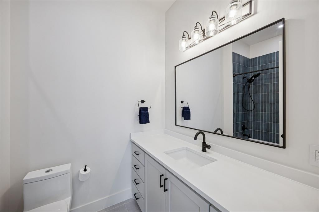 5104 Vandelia Street Dallas, TX 75235 - Photo 21 of 40 a bathroom with a sink and a mirror