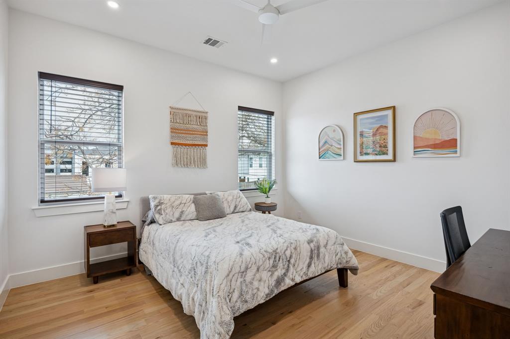 5104 Vandelia Street Dallas, TX 75235 - Photo 23 of 40 a bedroom with a bed and a chair