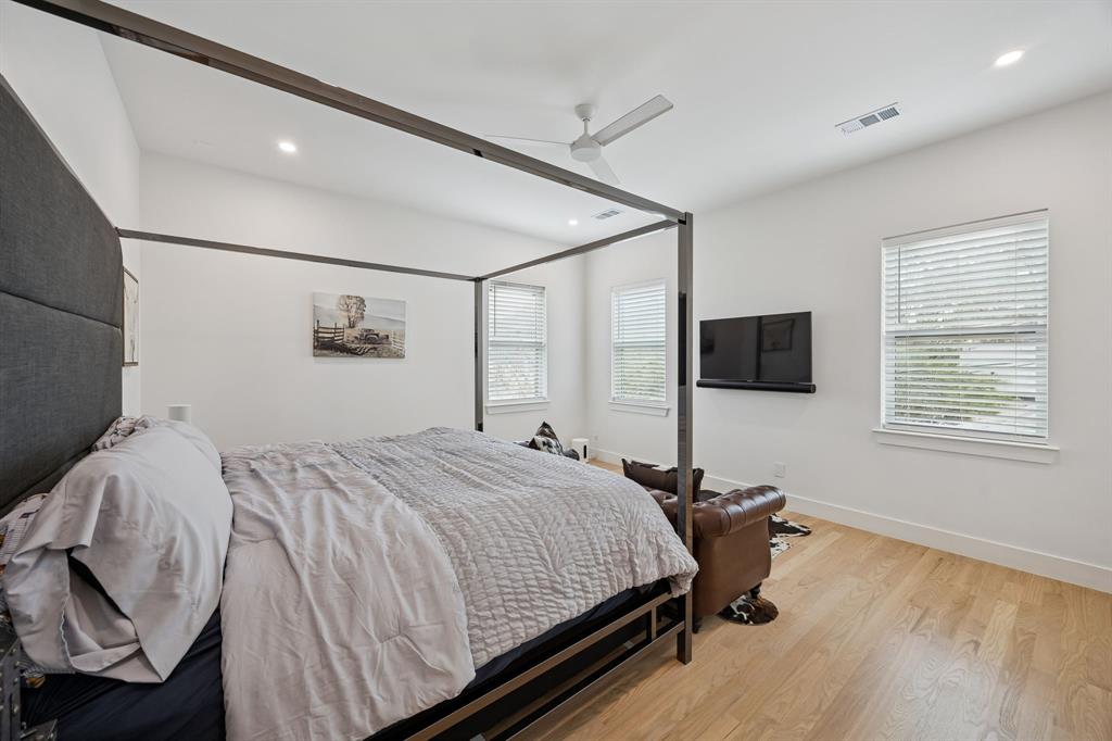 5104 Vandelia Street Dallas, TX 75235 - Photo 31 of 40 a bedroom with a bed and a flat screen tv