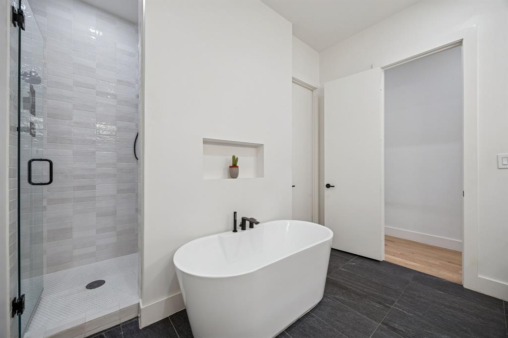 5104 Vandelia Street Dallas, TX 75235 - Photo 35 of 40 a white bath tub sitting next to a white sink