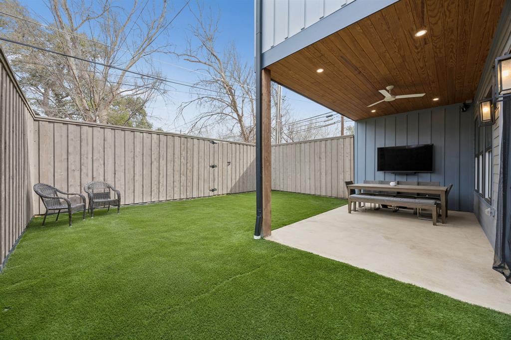 5104 Vandelia Street Dallas, TX 75235 - Photo 38 of 40 a view of a backyard with wooden fence and a bench