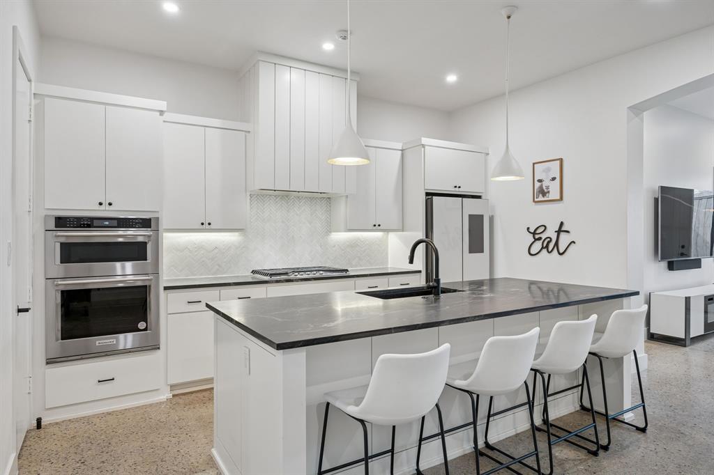 5104 Vandelia Street Dallas, TX 75235 - Photo 7 of 40 a kitchen with granite countertop white cabinets and stainless steel appliances