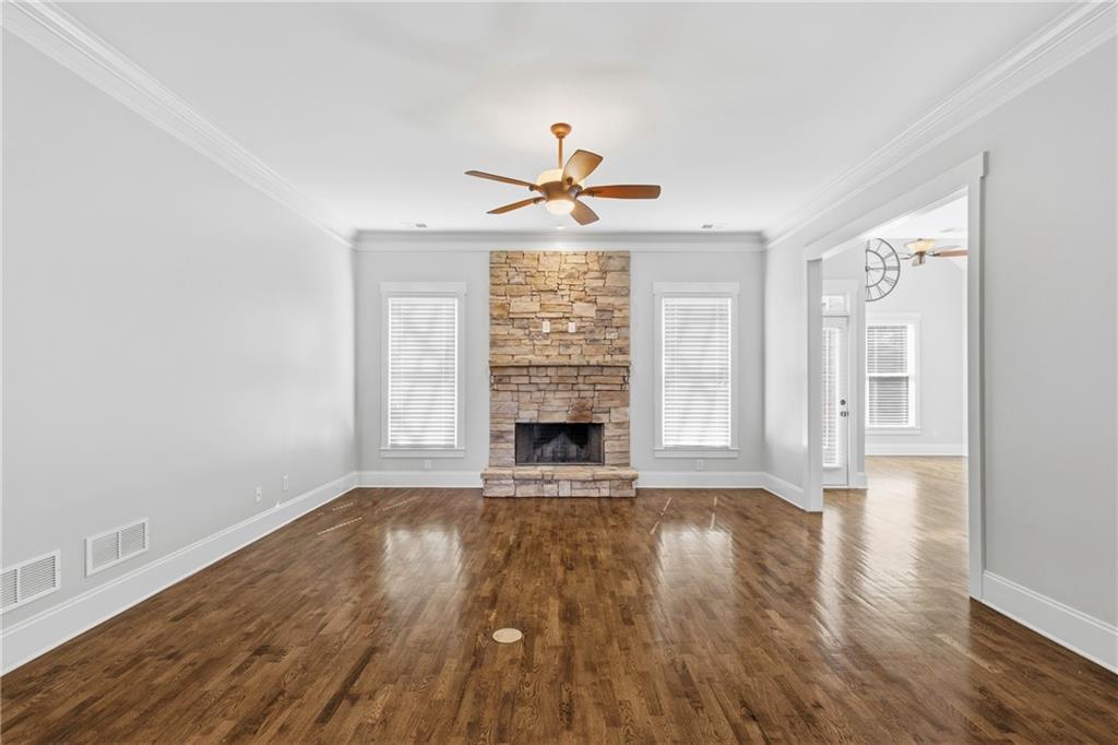 4340 Silent Path Cumming, GA 30028 - Photo 11 of 47 a view of empty room with wooden floor and fireplace