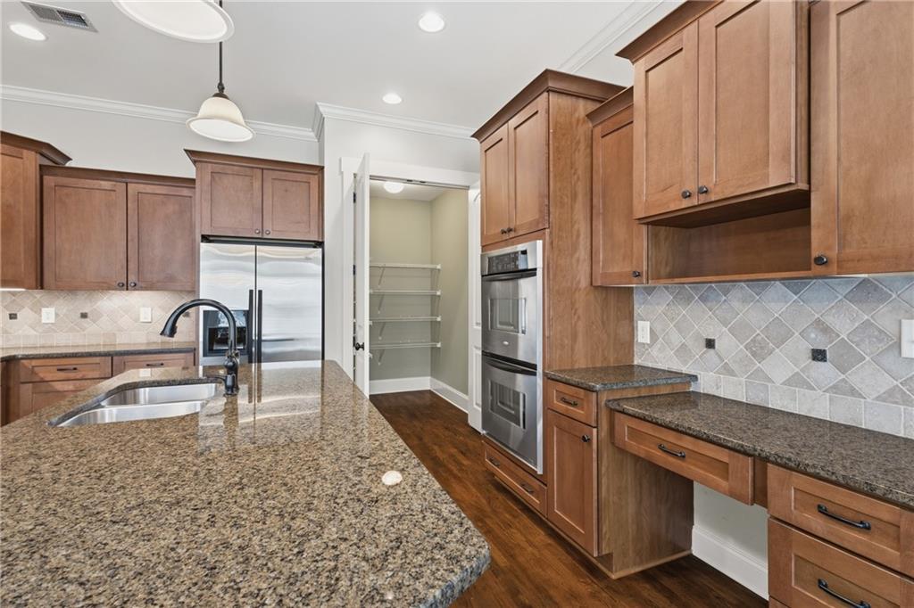 4340 Silent Path Cumming, GA 30028 - Photo 15 of 47 a kitchen with stainless steel appliances granite countertop a refrigerator and a stove top oven