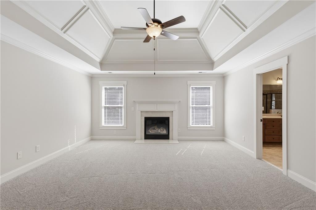 4340 Silent Path Cumming, GA 30028 - Photo 24 of 47 a view of a livingroom with a fireplace and a chandelier fan
