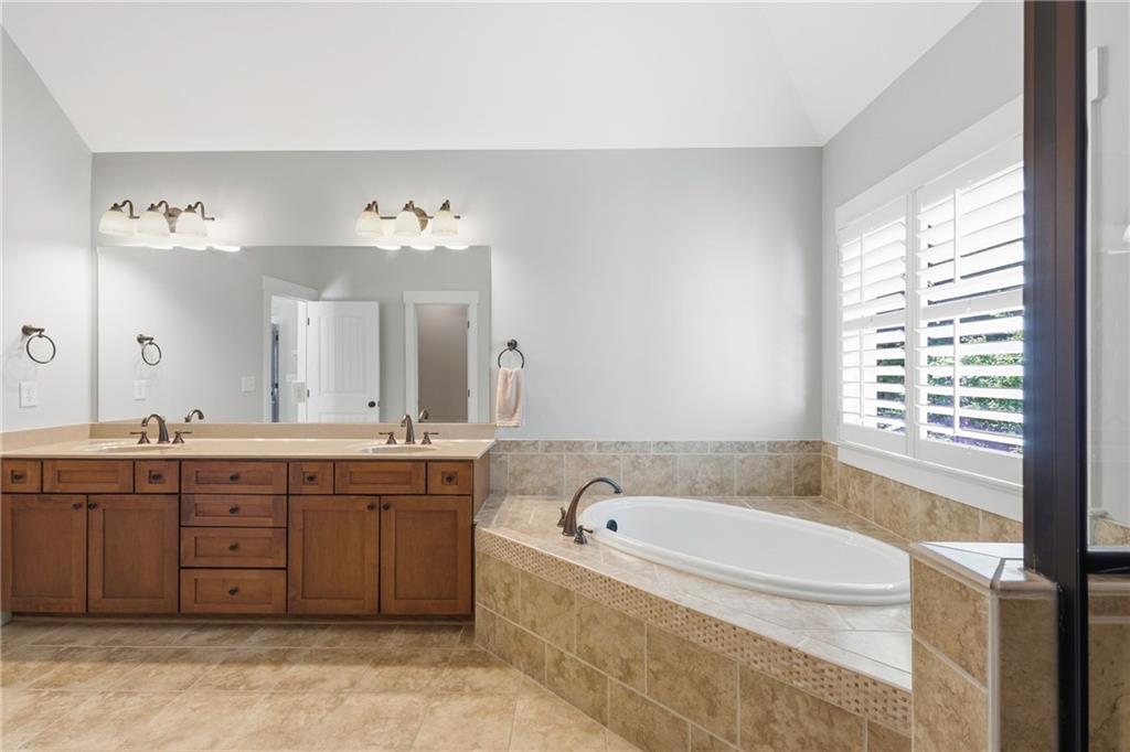 4340 Silent Path Cumming, GA 30028 - Photo 26 of 47 a spacious bathroom with a tub sink and mirror