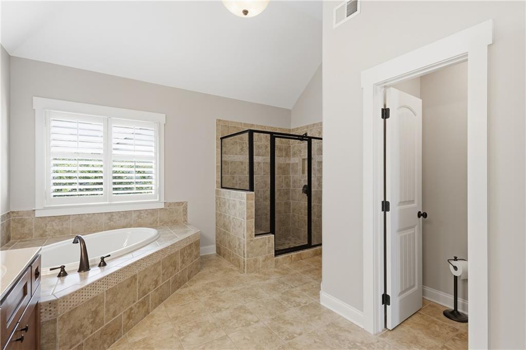 4340 Silent Path Cumming, GA 30028 - Photo 27 of 47 a bathroom with a bathtub and a shower
