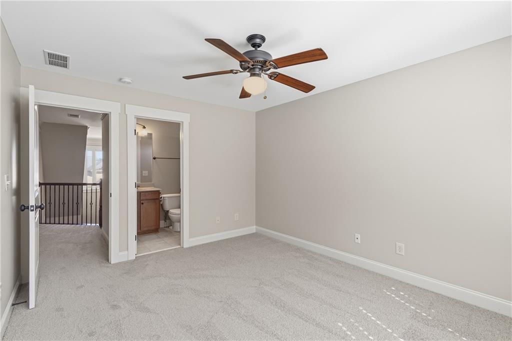 4340 Silent Path Cumming, GA 30028 - Photo 30 of 47 an empty room with closet and a ceiling fan