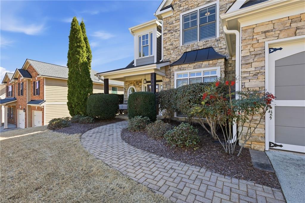 4340 Silent Path Cumming, GA 30028 - Photo 3 of 47 a view of a brick building next to a yard
