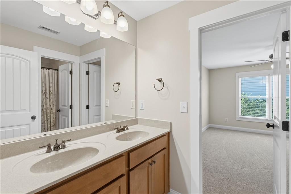 4340 Silent Path Cumming, GA 30028 - Photo 33 of 47 a bathroom with a sink vanity tub and a mirror