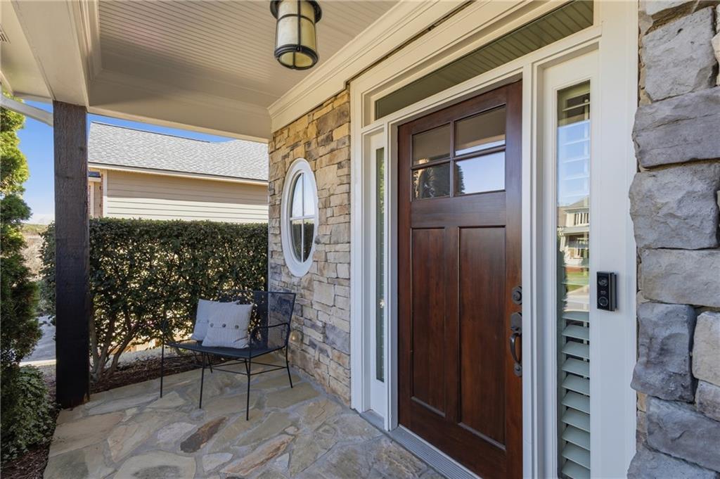 4340 Silent Path Cumming, GA 30028 - Photo 4 of 47 a view of a porch with a table and chairs and couches with wooden floor