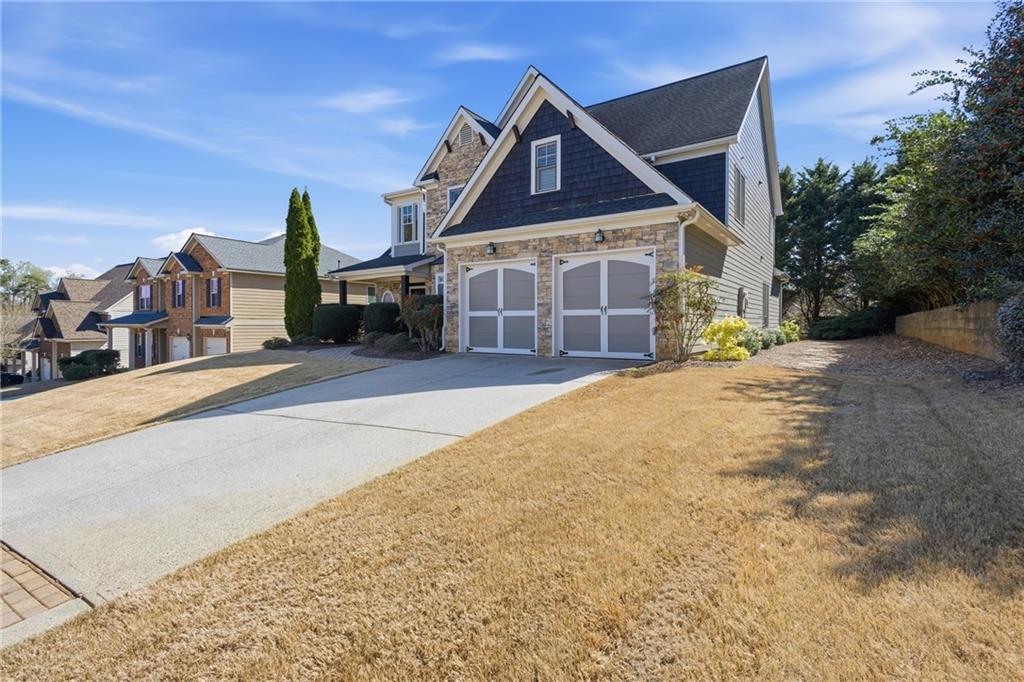 4340 Silent Path Cumming, GA 30028 - Photo 45 of 47 a front view of a house with a yard and garage