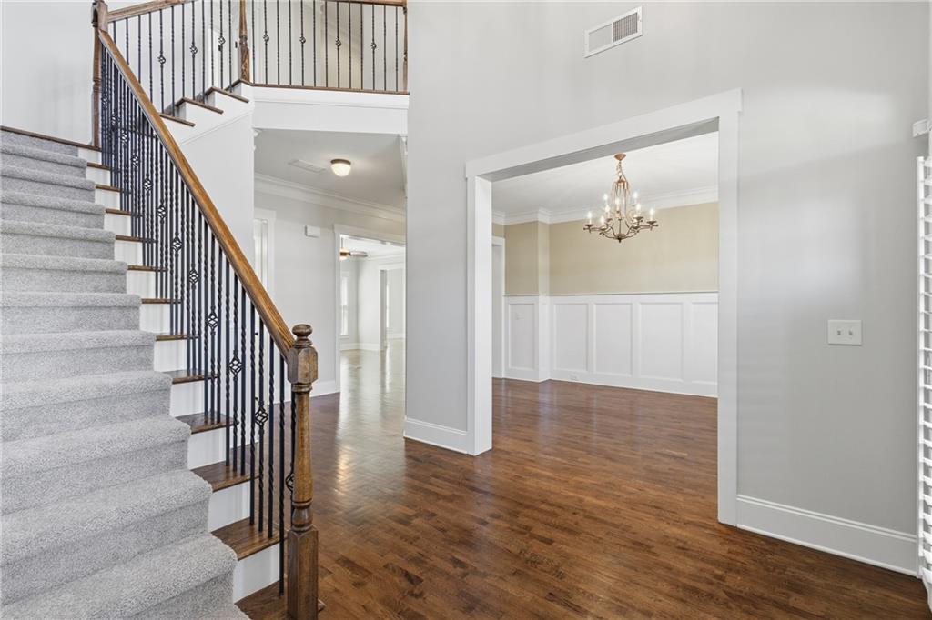 4340 Silent Path Cumming, GA 30028 - Photo 6 of 47 a view of a hallway with wooden floor and staircase