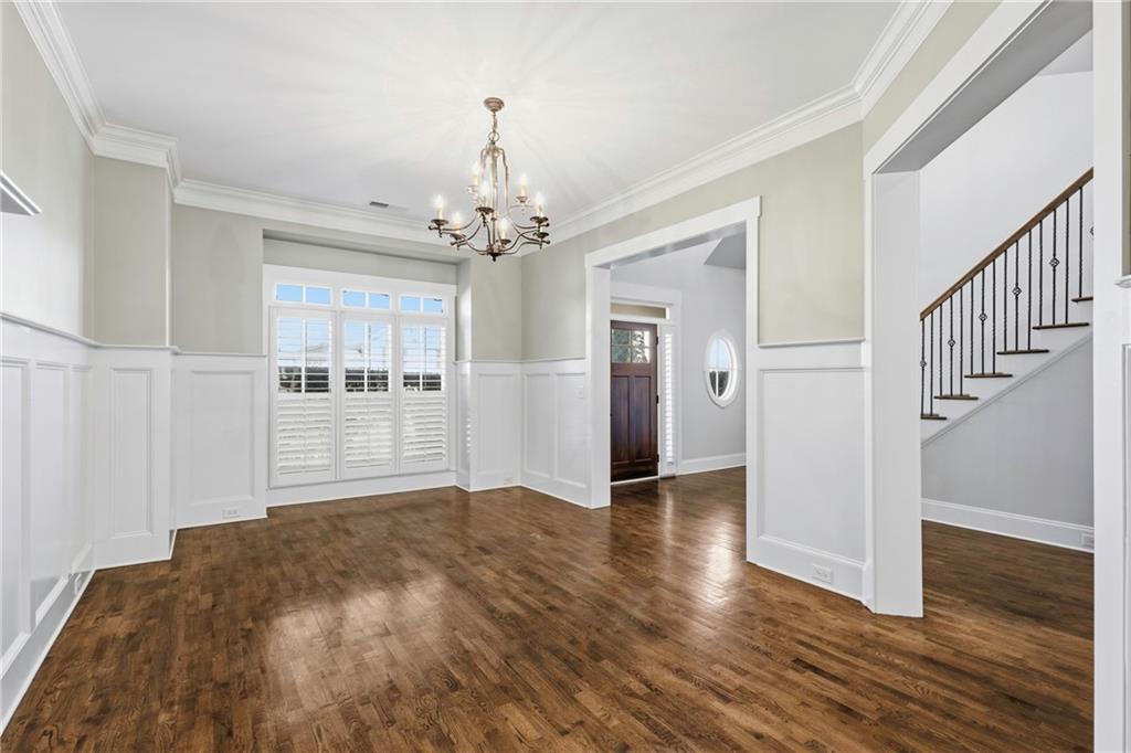4340 Silent Path Cumming, GA 30028 - Photo 8 of 47 a view of empty room with wooden floor and kitchen
