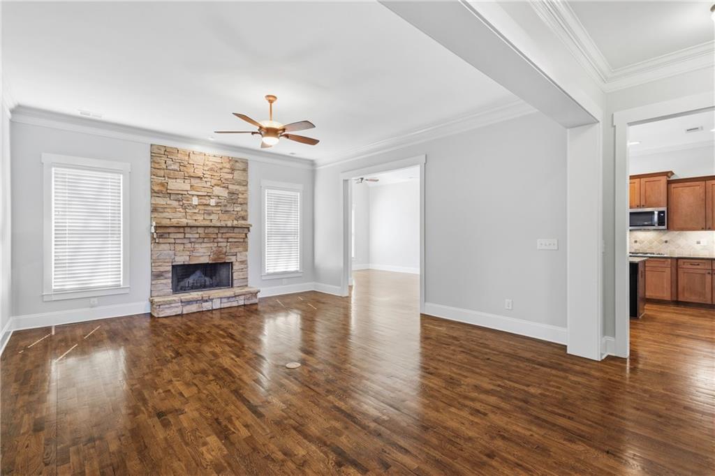 4340 Silent Path Cumming, GA 30028 - Photo 10 of 47 a view of an empty room with wooden floor and a window