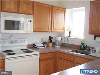 8007 Westview Road, Unit 7 Wilmington, DE 19802 - Photo 3 of 6 a kitchen with sink a microwave and cabinets