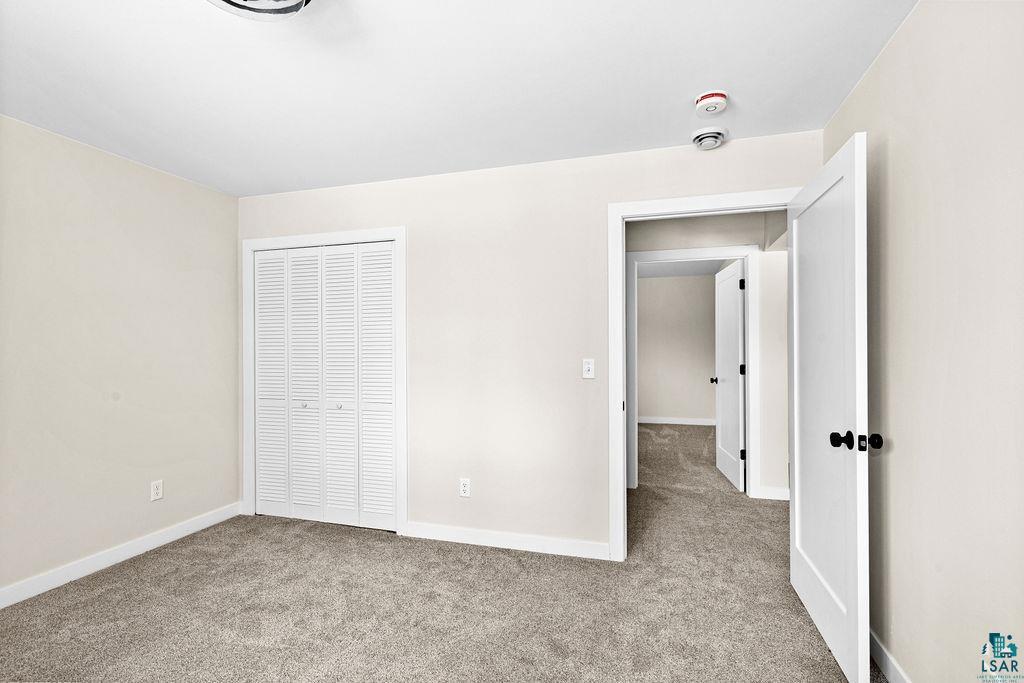 2236 Hoover Street Duluth, MN 55811 - Photo 35 of 52 Unfurnished bedroom featuring light colored carpet and a closet