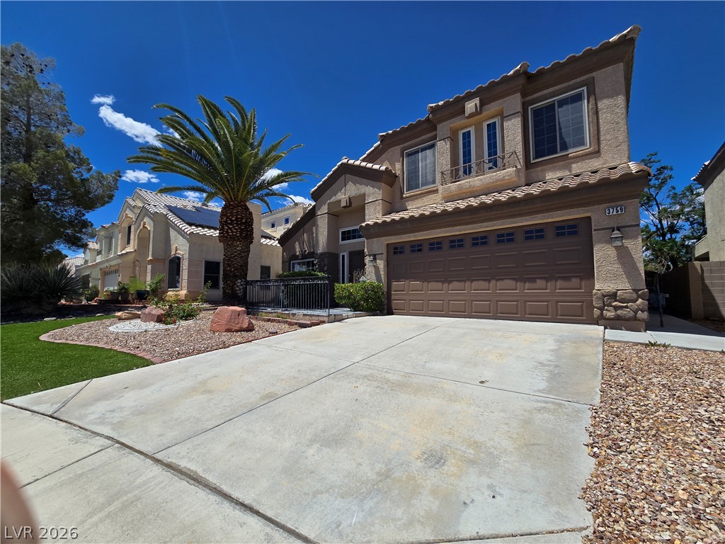 3759 Funston Way Las Vegas, NV 89129 - Photo 1 of 31 A well-maintained desert landscape frames this property with a spacious driveway and attached garage.