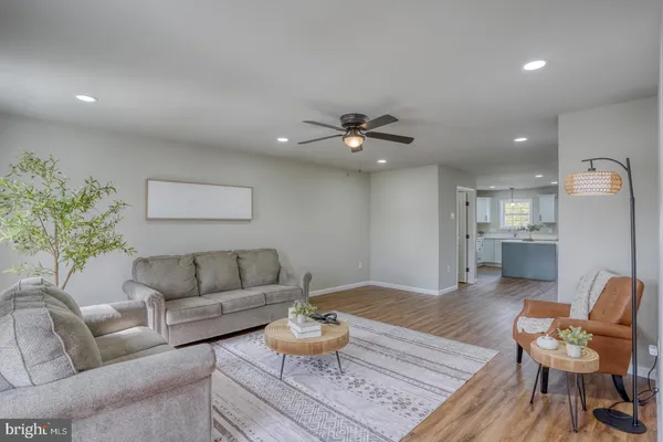 a living room with furniture and kitchen view