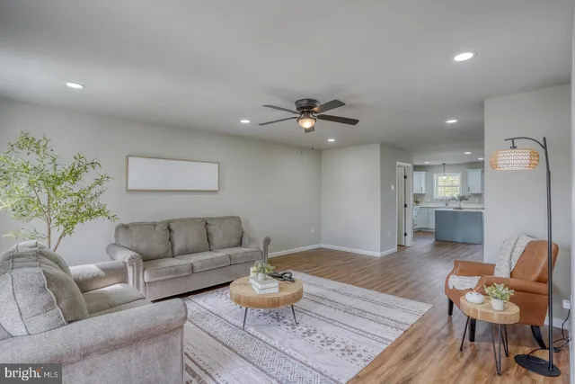 a living room with furniture and kitchen view