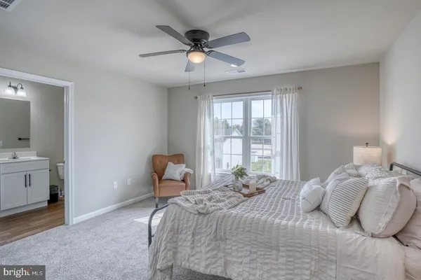 a bedroom with a bed and a chair