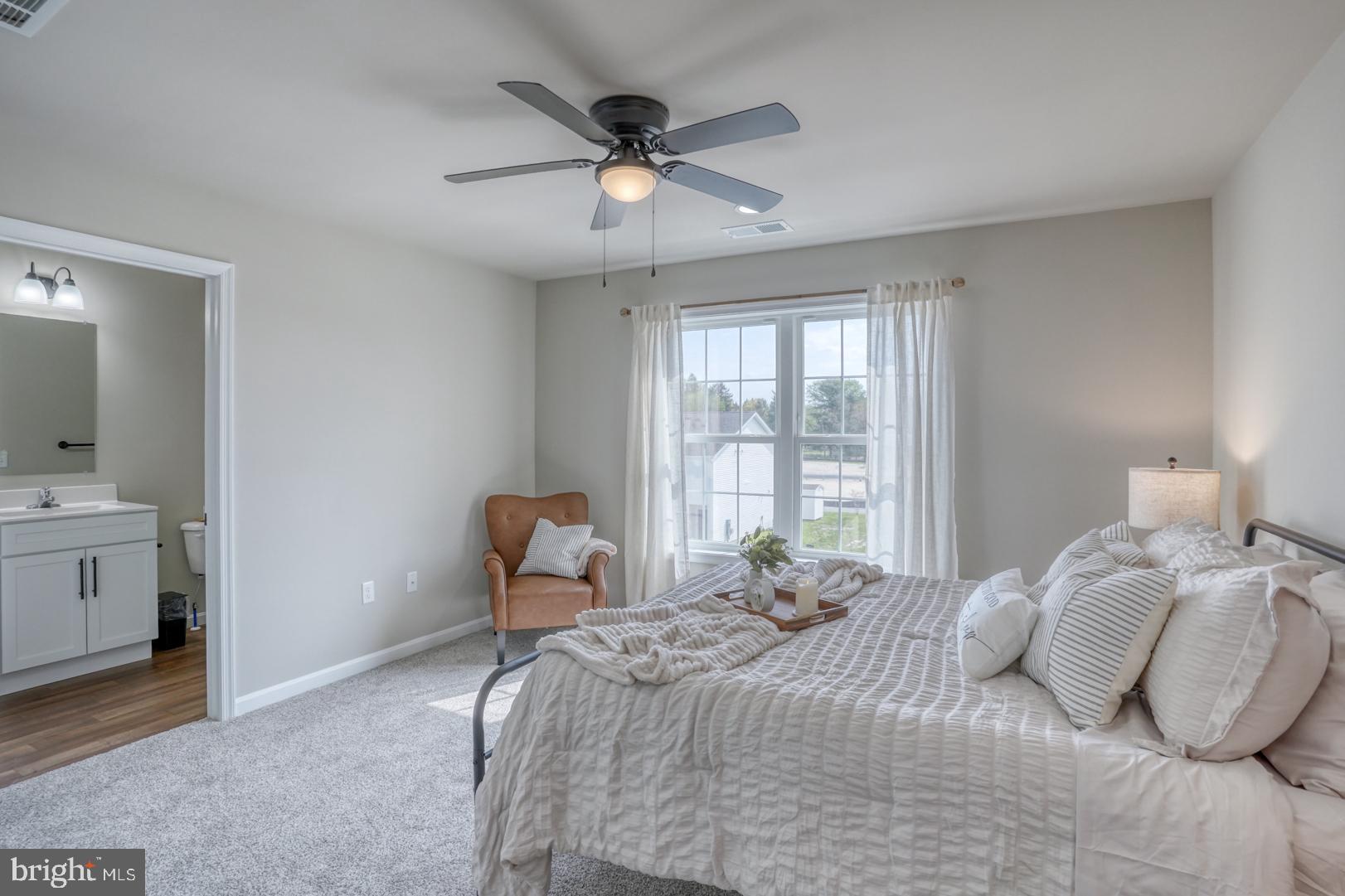 210 Rojan Road, Unit MODEL Dover, DE 19901 - Photo 16 of 17 a bedroom with a bed and a chair
